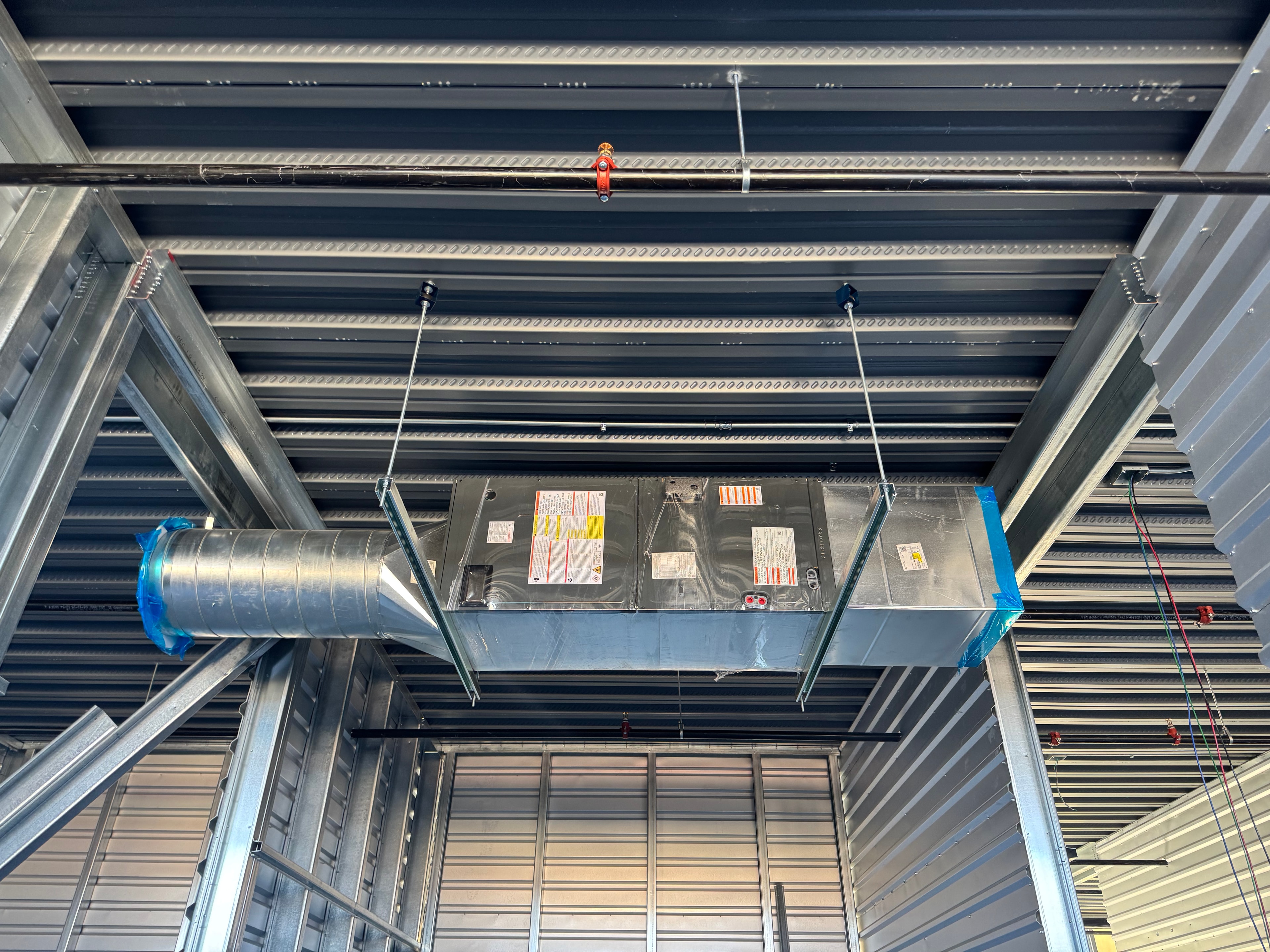 Fan coil unit with round supply and plenum
