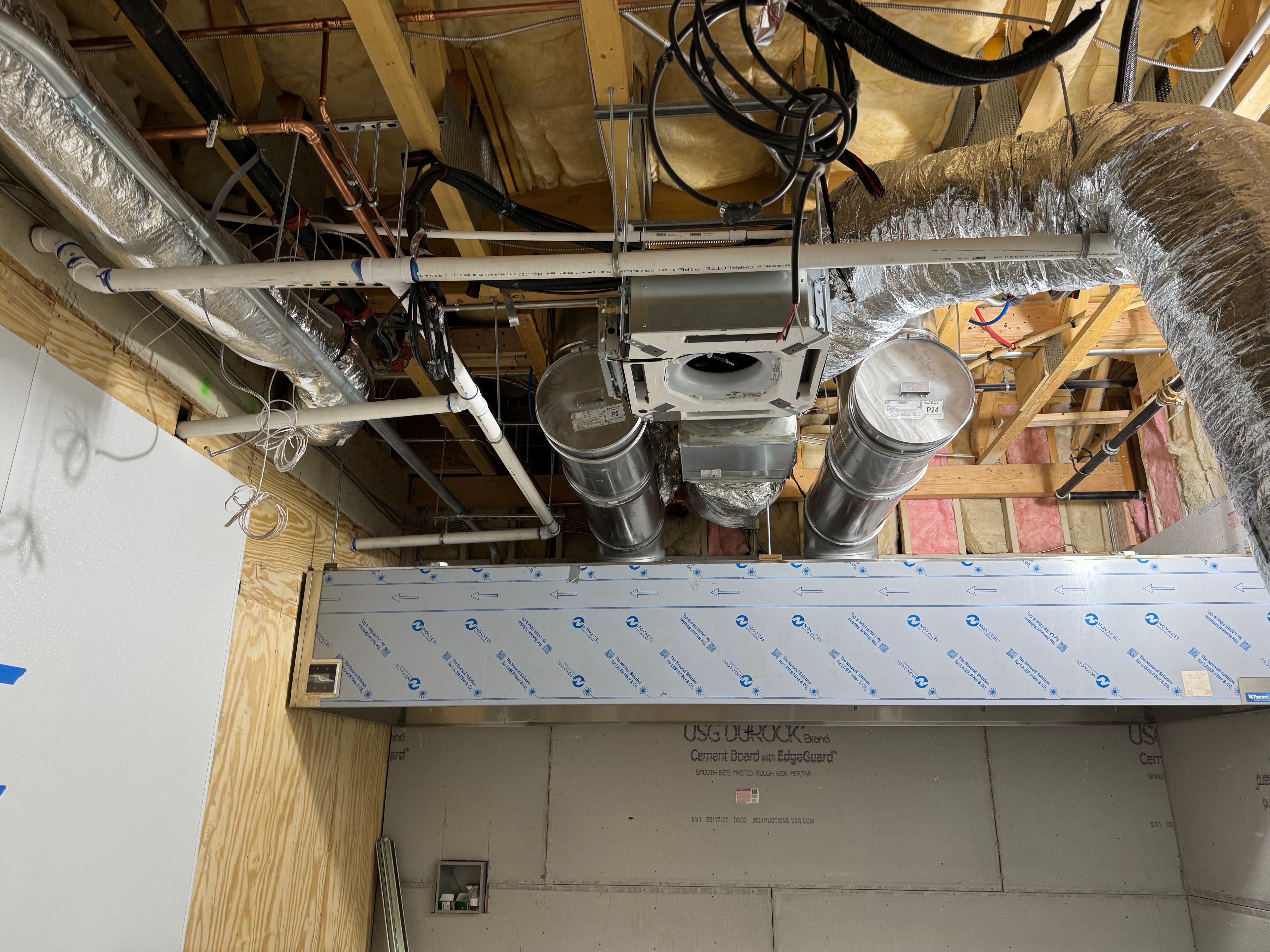 Cassette fan coil units with round supply drops above hood