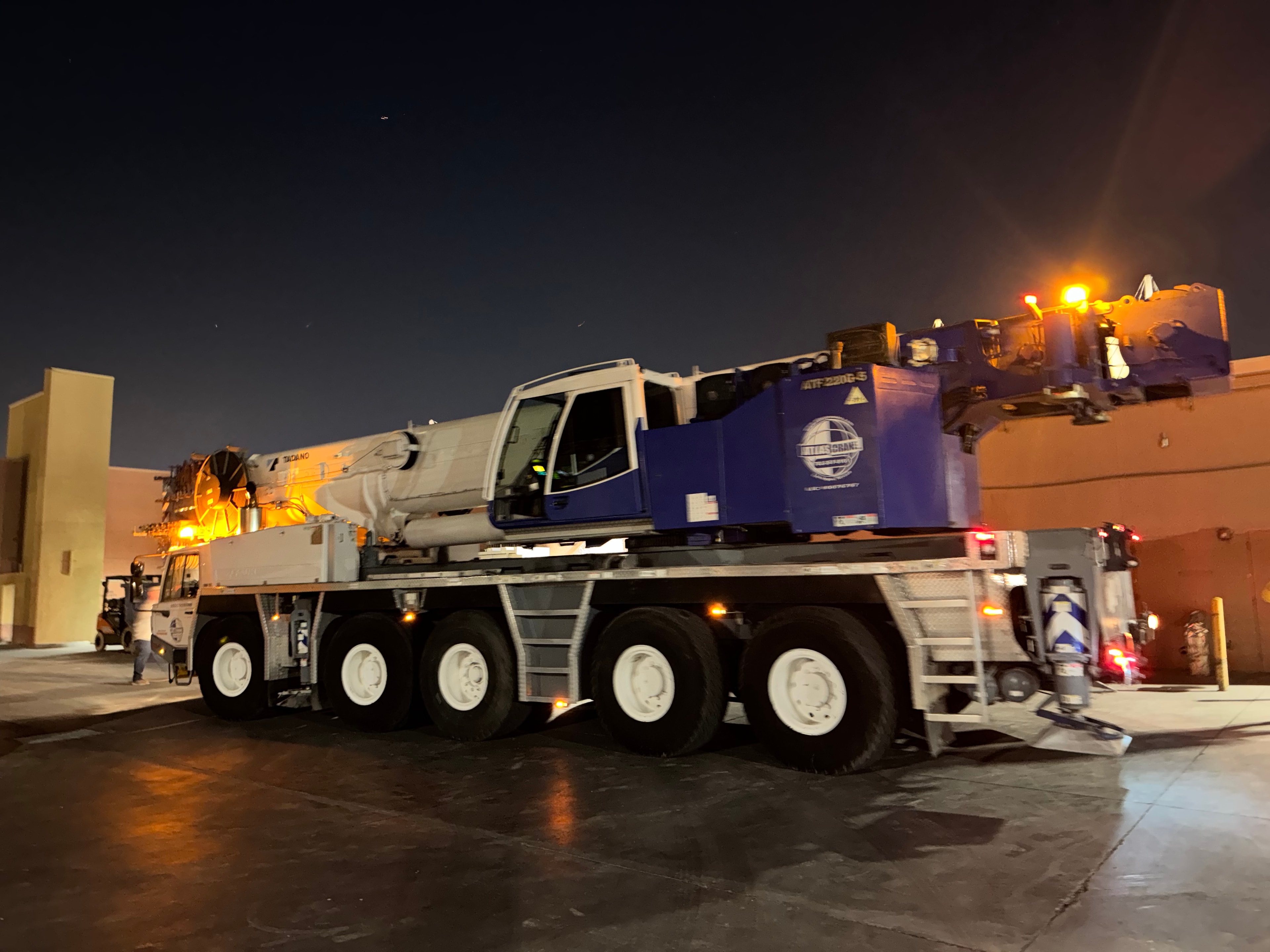 Nighttime crane set — rooftop equipment placement